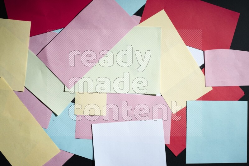 Multicolored paper sheet on black background