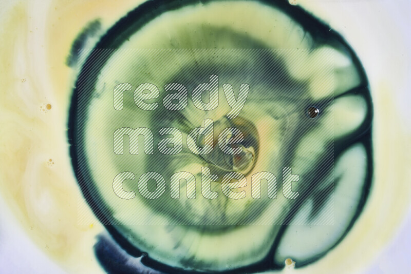 A close-up of abstract swirling patterns in yellow and green