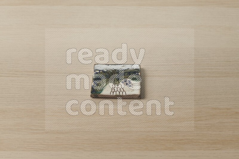 A decorative coaster on light wooden background