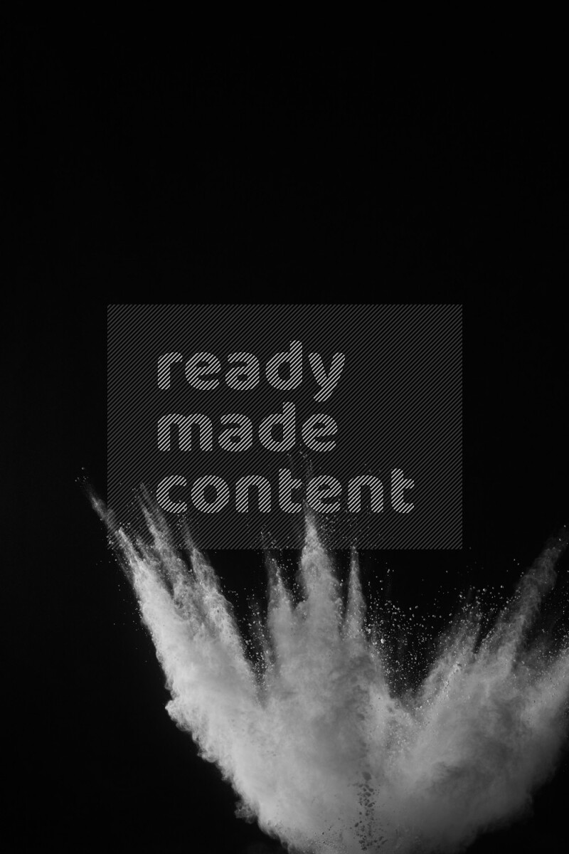 A side view of white powder explosion on black background