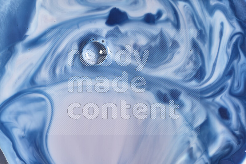 A close-up of abstract swirling patterns in blue, red and white