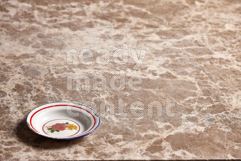 A vintage metal plate on beige marble background