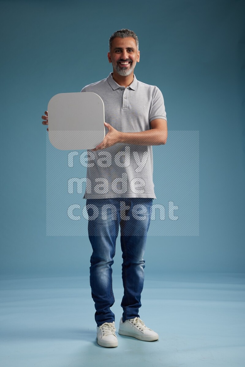 Man Standing holding social media sign on blue background