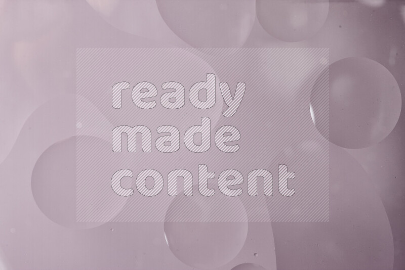 Close-ups of abstract oil bubbles on water surface in shades of grey