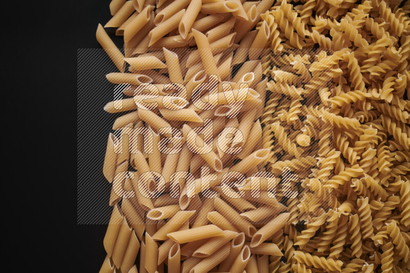 Different pasta types on black background