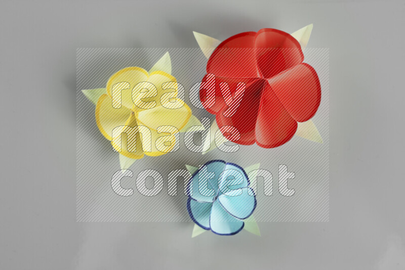 Origami flower on grey background
