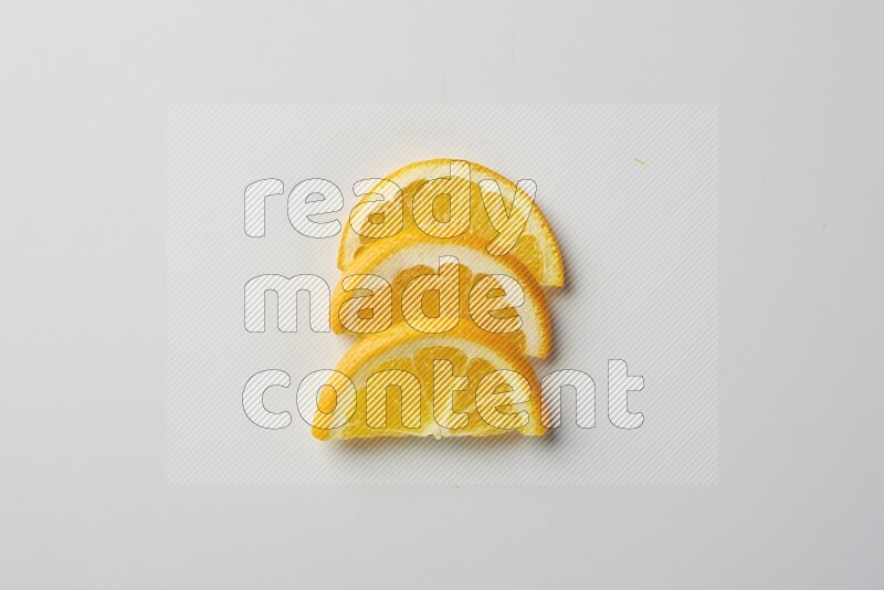 Three halves of an orange slices on white background