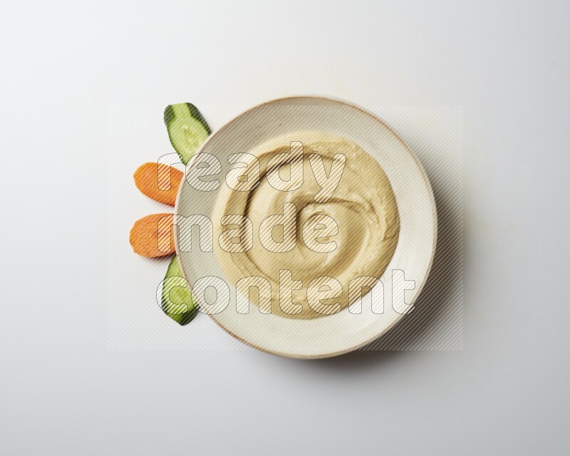 plain Hummus in a pottry plate  on a white background