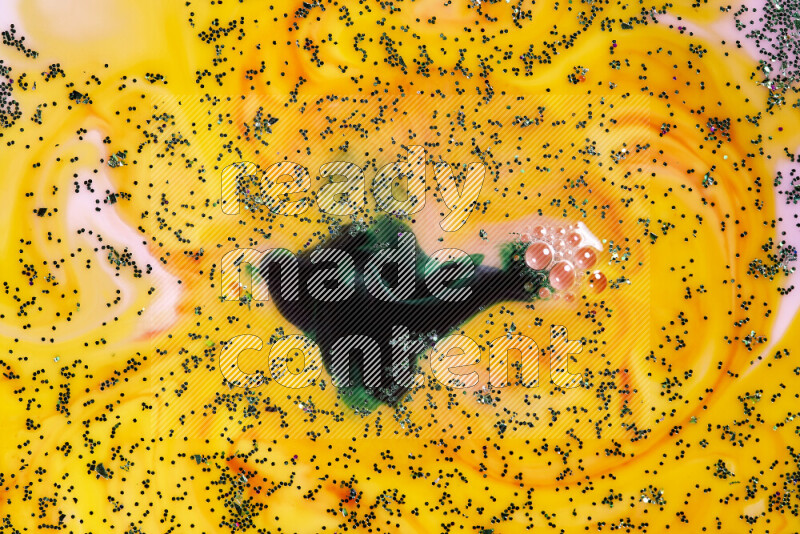 A close-up of sparkling green glitter scattered on swirling yellow and green background