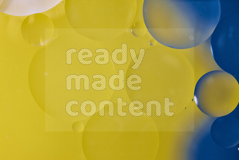 Close-ups of abstract oil bubbles on water surface in shades of blue and yellow