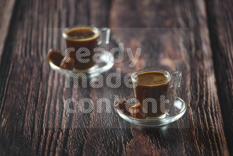 A coffee glass cup with dates and tea on wooden background