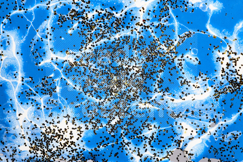Abstract colorful background with mixed of blue and white paint colors with scattered gold glitter