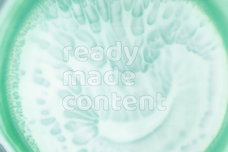 A close-up of abstract swirling patterns in green gradients