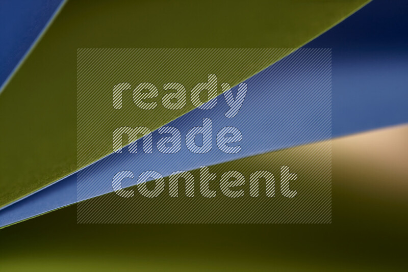 An abstract art showing blue and green paper sheets arranged in an overlapping curves