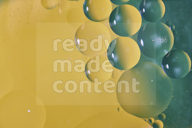 Close-ups of abstract oil bubbles on water surface in shades of green and yellow