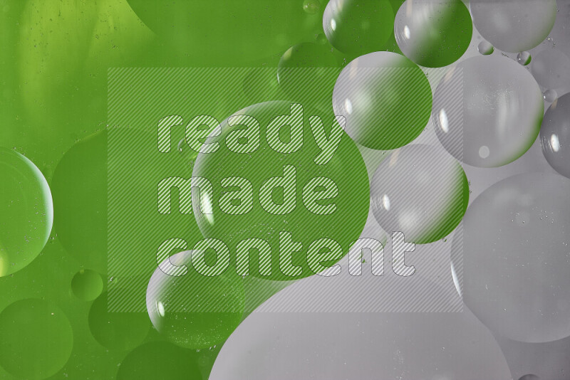 Close-ups of abstract oil bubbles on water surface in shades of white and green