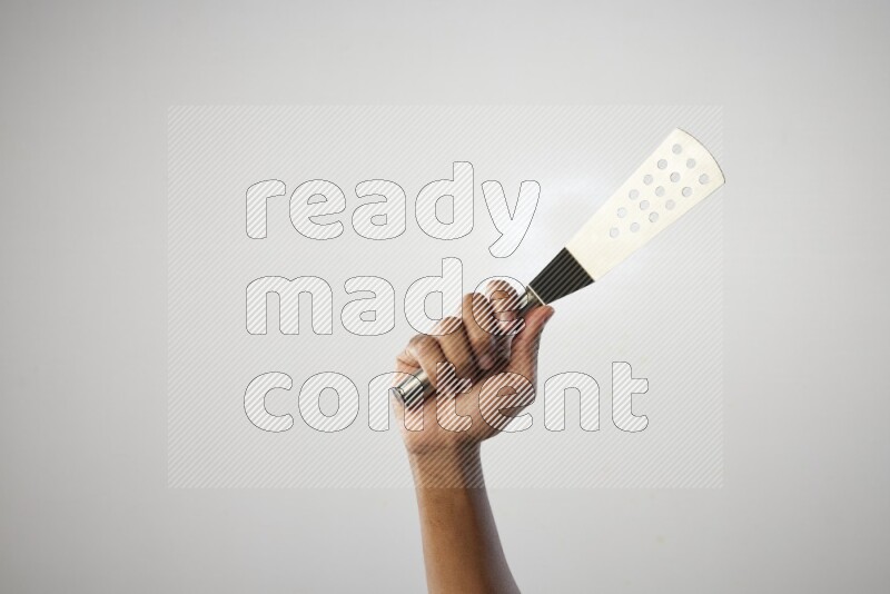 Male Hand Holding Burger Flipper on white background