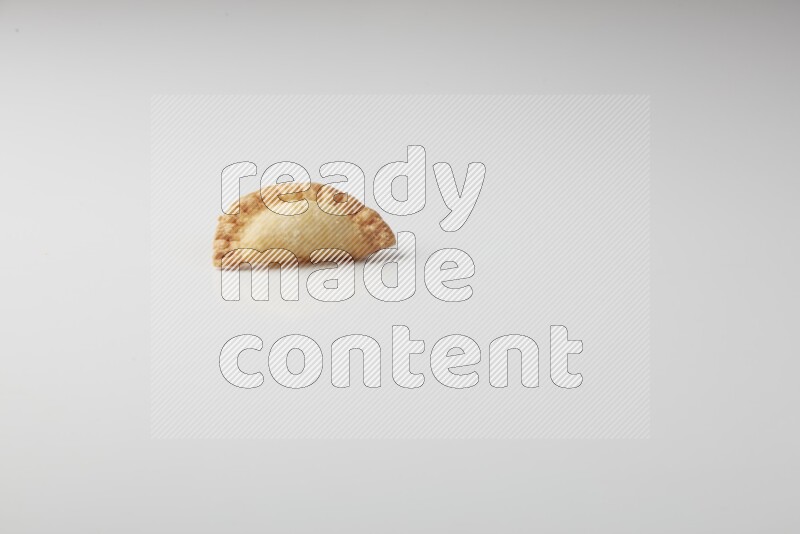 One fried sambosa on a white background