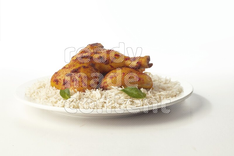 white  basmati Rice with  kabsa chicken pieces  on a white rounded plate direct on white background