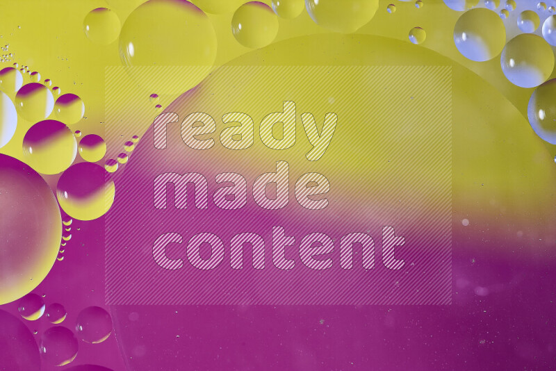 Close-ups of abstract oil bubbles on water surface in shades of yellow and pink