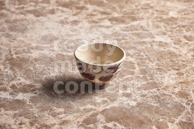 A decorative pottery bowl on beige marble background