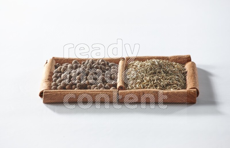 2 squares of cinnamon sticks full of allspice and cumin on white flooring