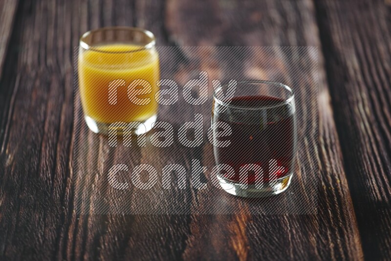 Cold drinks in a glass cup such as water, tamarind, qamar eldin, sobia, milk and hibiscus on wooden background