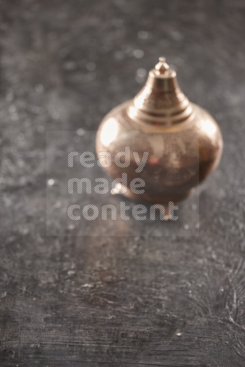 An out of focus lantern on textured black background