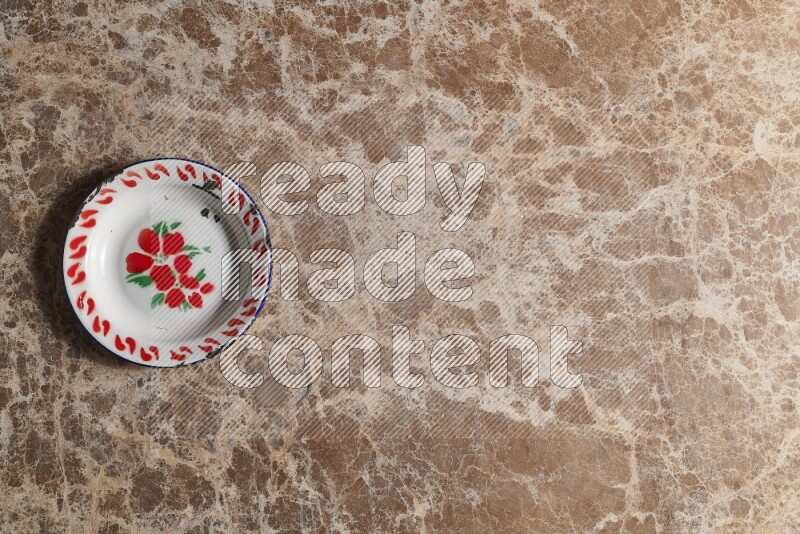 A vintage metal plate on beige marble background