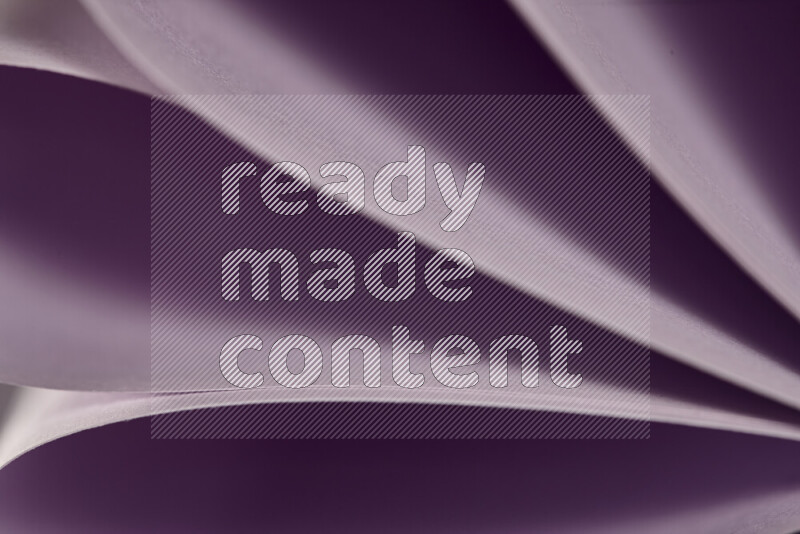 An abstract art showing purple paper sheets arranged in an overlapping curves