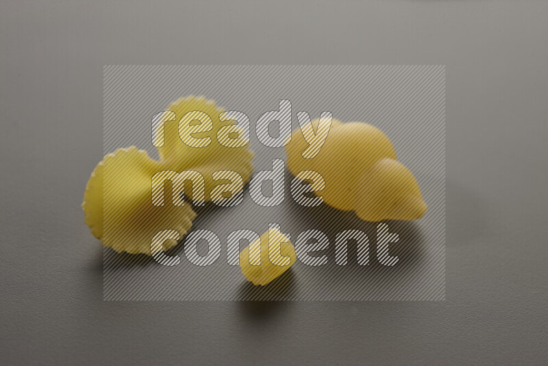 Different pasta types on grey background