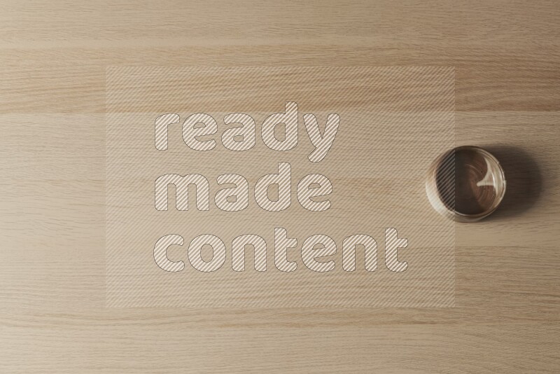 A brown pottery bowl on light wooden background