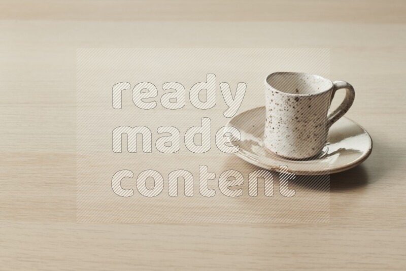 A pottery cup on light wooden background