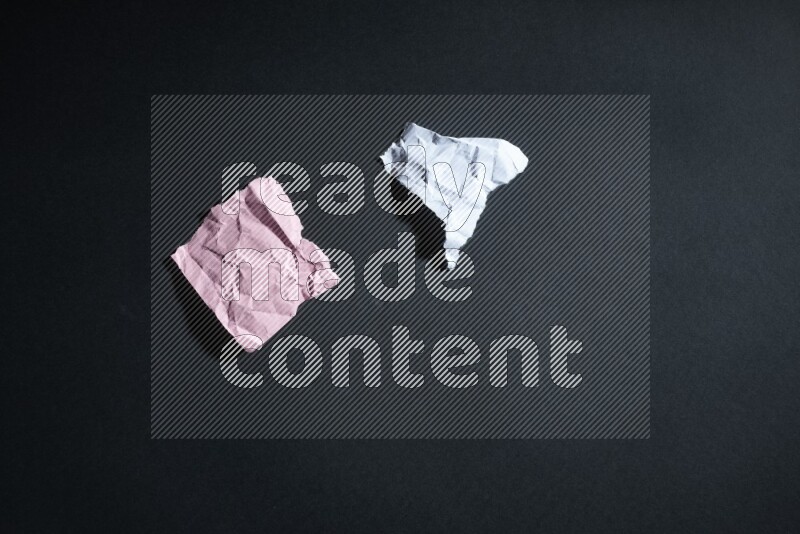 Crumpled multicolored paper on black background