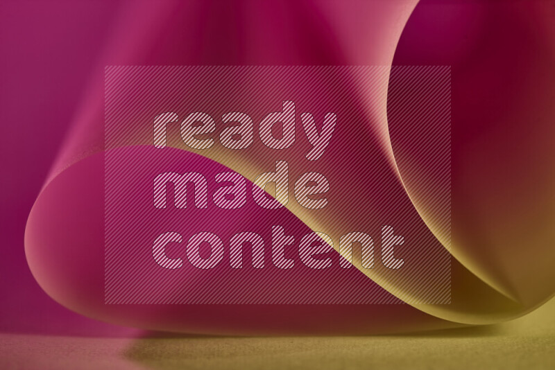 An abstract art piece displaying smooth curves in gold and pink gradients created by colored light