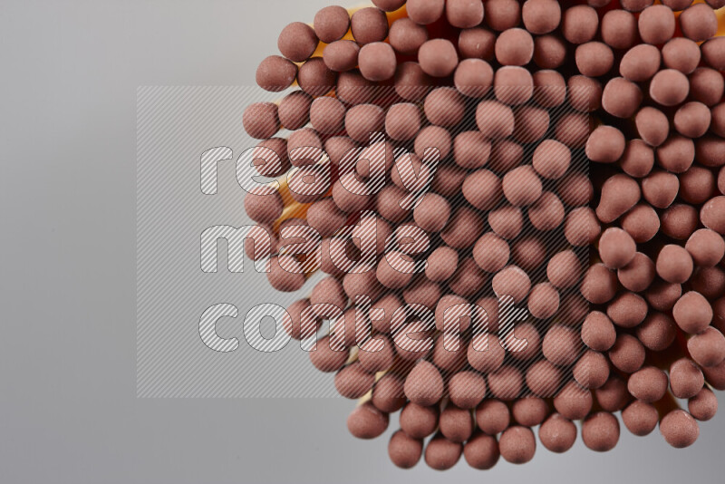 A close-up of a bundle of matches on grey background