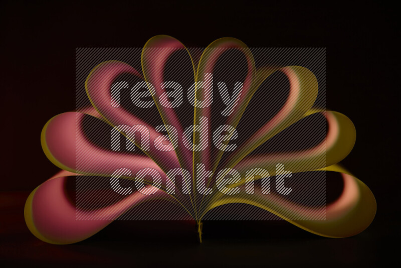 An abstract art piece displaying smooth curves in yellow and red gradients created by colored light