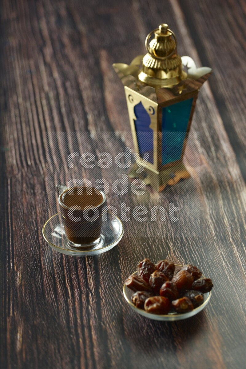 A golden lantern with different drinks, dates, nuts, prayer beads and quran on brown wooden background
