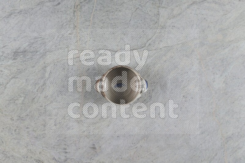 A multicolored pottery Bowl on grey marble background