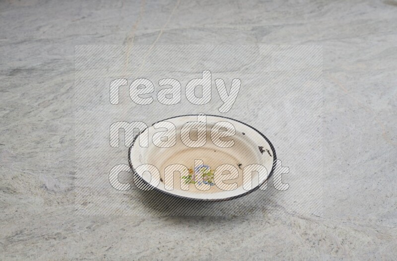 A vintage metal plate on grey marble background