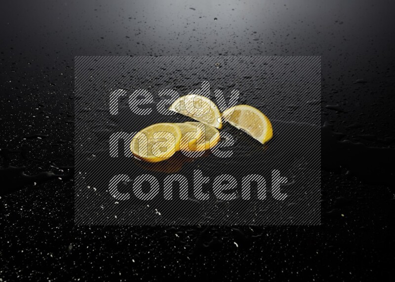 Lemon slices with water drops, and droplets on black background