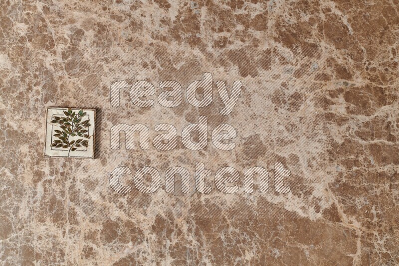 A decorative coaster on beige marble background