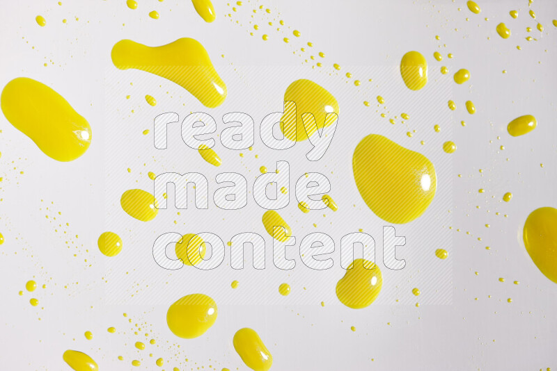 Close-ups of abstract yellow paint droplets on white background