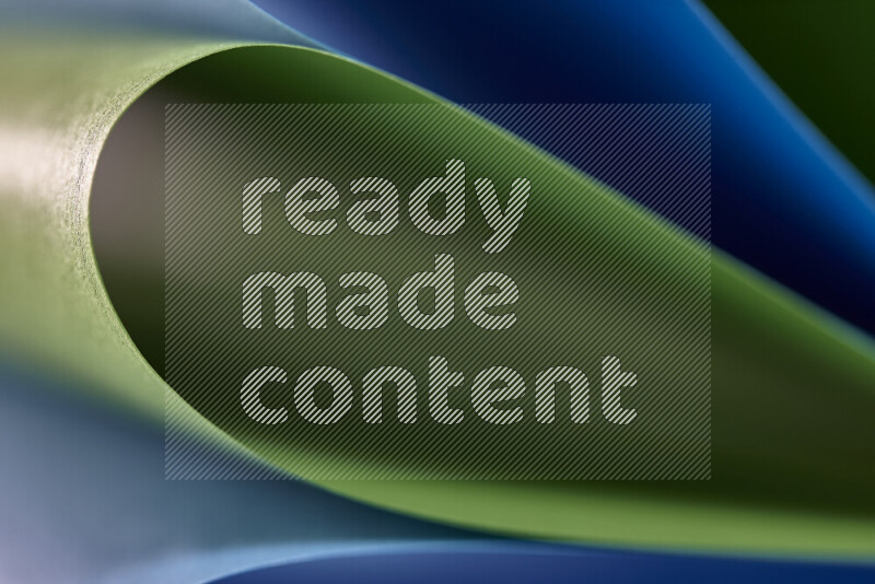 An abstract art showing blue and green paper sheets arranged in an overlapping curves