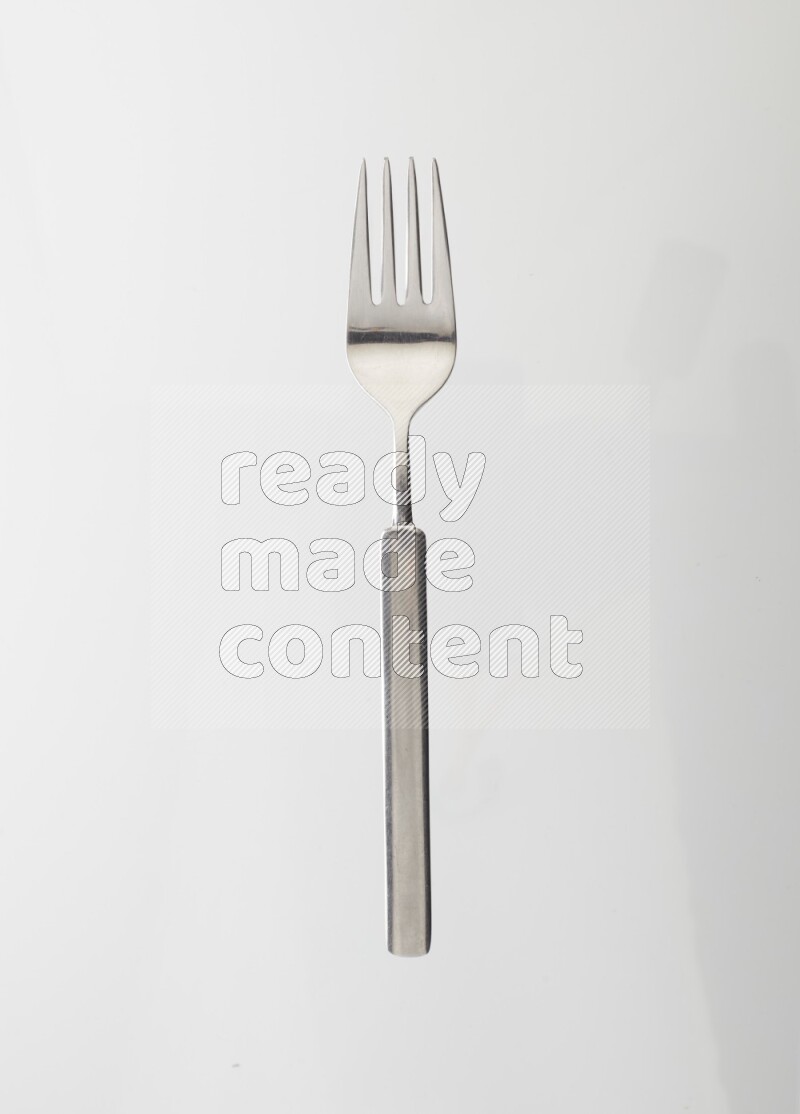 Silver stainless steel fork on white background