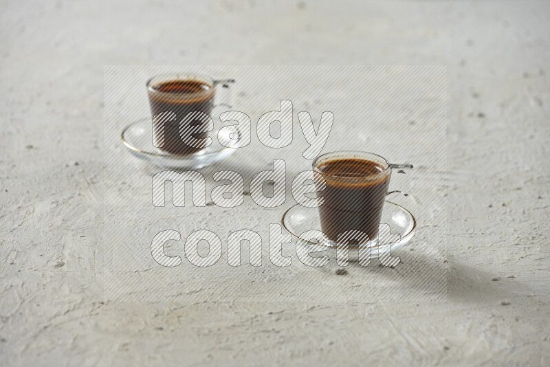 A coffee glass cup with dates and tea on textured white background