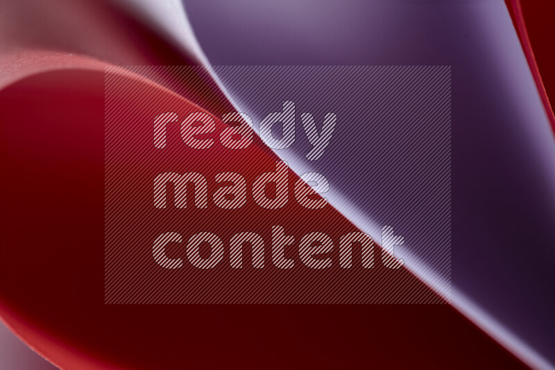 An abstract art showing purple and red paper sheets arranged in an overlapping curves
