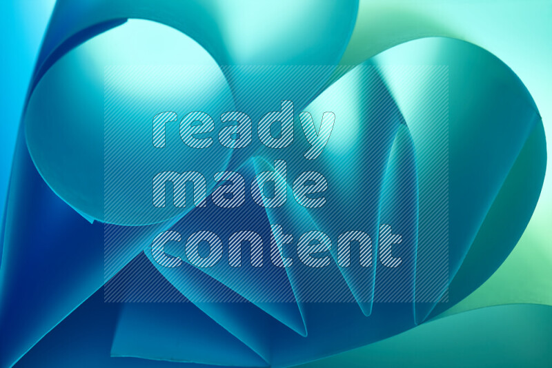 An artistic display of paper folds creating a harmonious blend of geometric shapes, highlighted by soft lighting in green and blue tones