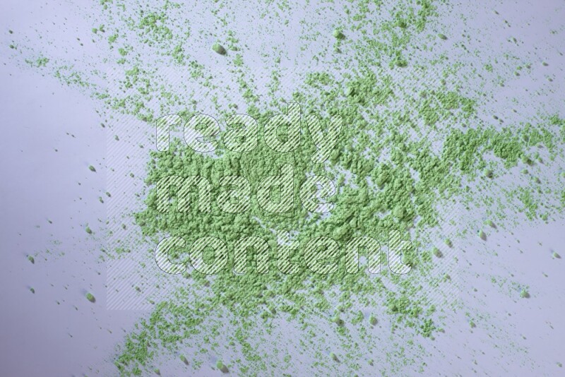 Green powder on white background