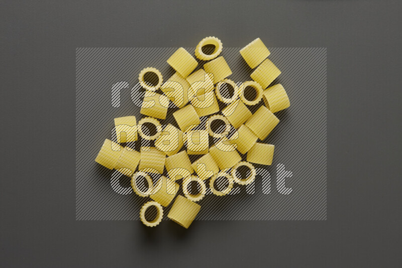 Big rings pasta on grey background